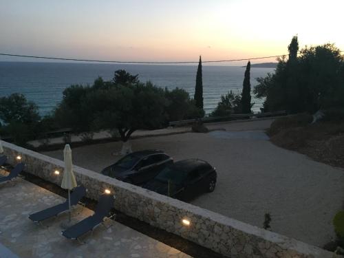 a car parked in a parking lot near the ocean at Anna Studios in Lourdhata