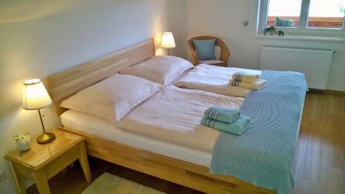 a large white bed with two pillows on it at Appartement Kohlnberger in Waidhofen an der Ybbs