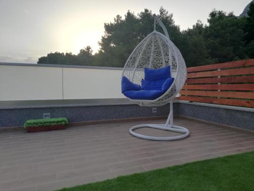 a swing sitting on top of a roof at Apartments Villa Katija in Drvenik