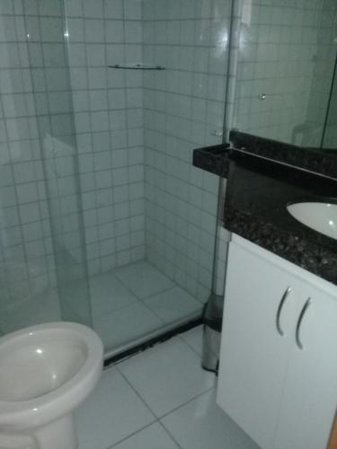 a bathroom with a shower and a toilet and a sink at Flat Monte Castelo em Gravata PE in Gravatá
