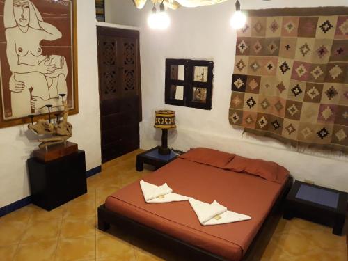 a room with a bed and a painting on the wall at Casa Constantino in Rivera
