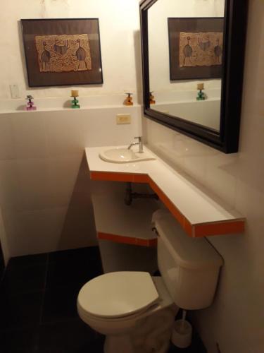 a bathroom with a toilet and a sink and a mirror at Casa Constantino in Rivera