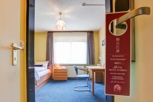 a hotel room with a bed and a desk at Hotel Elbinsel free parking in Hamburg