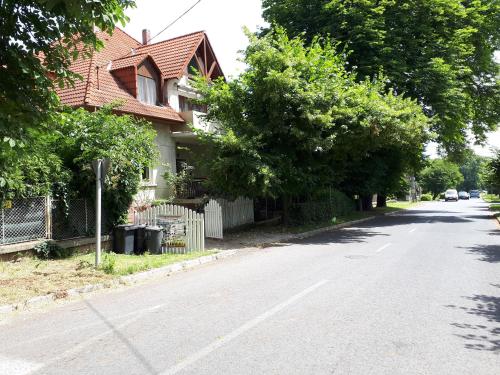 a house on the side of a street at Magdi apartman in Keszthely