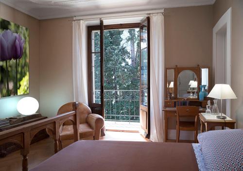マルティニーにあるVilla de Maîtreのベッドルーム1室(ベッド1台付)、大きな窓(デスク付)