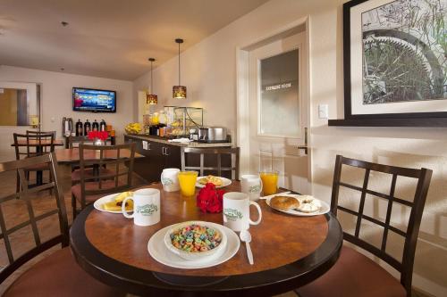a dining room with a table with food on it at Granzella's Inn in Williams