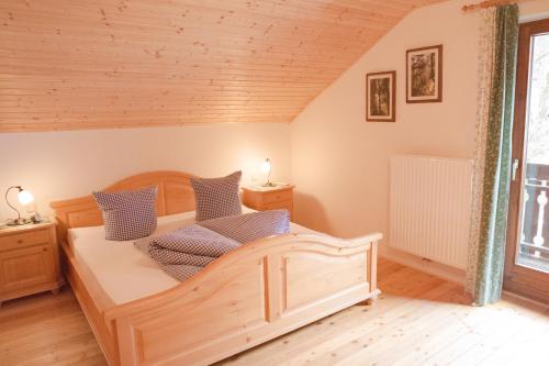 1 dormitorio con cama de madera y almohadas azules en Urlaub mitten im Wald - Lueg, en Scheibbs