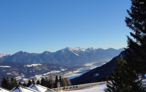 a view of a snowy mountain with mountains in the background at Apartments Susanne und Jasmin - Haus Sonnleitn in Sonnenalpe Nassfeld