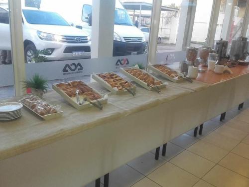 a table with several trays of pastries on it at Hotel ACA Santa Rosa in Santa Rosa