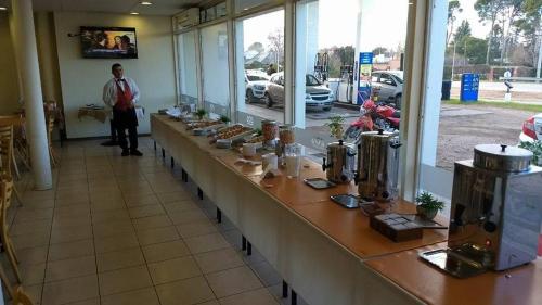 a man standing behind a long counter in a restaurant at Hotel ACA Santa Rosa in Santa Rosa