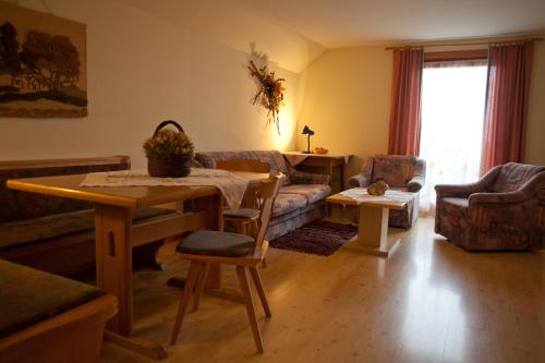 a living room with a table and a couch at Eggerhof in Ramsau am Dachstein