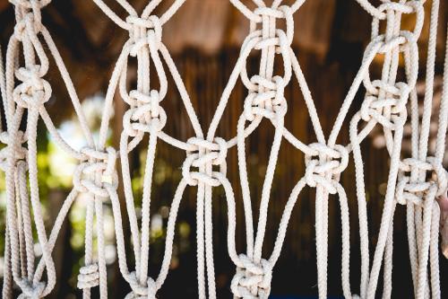 a bunch of ropes hanging from a fence at Casa Takywara in Holbox Island
