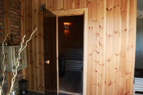 a wooden room with a door leading to a staircase at Dzika Chata in Nowy Barkoczyn