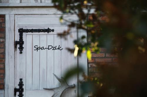 a garage door with a deer head on it at Dzika Chata in Nowy Barkoczyn
