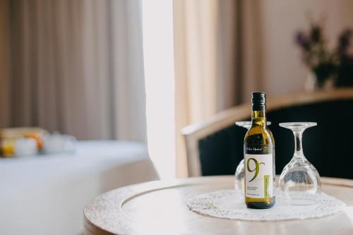 a bottle of wine and a wine glass on a table at Areos in Athens