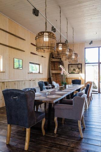 a dining room with a long table and chairs at Bottengarn Boutique Guesthouse in Koguva