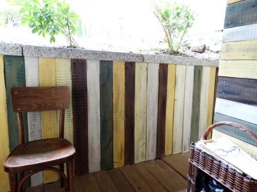 a chair sitting on a porch with a stripe wall at ROYAL apartment in Gabrovo