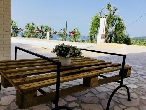 a wooden bench with a potted plant on it at Borgo Canneto in Rodi Garganico