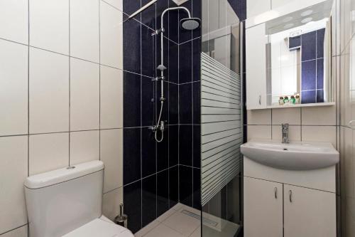 a bathroom with a toilet and a sink at Apartments Valentino in Ohrid