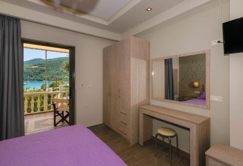 a bedroom with a purple bed and a fireplace at Villa Regina in Keri