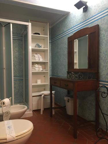 a bathroom with a sink and a toilet and a mirror at B&B Il Portico in Sarzana