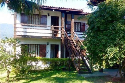 a house with a staircase leading up to it at Pousada Conde do Mar in Ilhabela