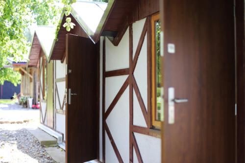 an open door of a house with a wooden door at Rasos sodyba in Prienai