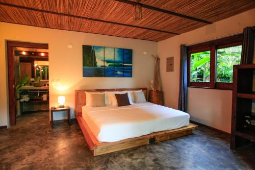 a bedroom with a large bed in a room at Lua Villas in Santa Teresa Beach
