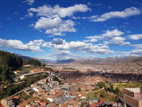 an aerial view of a city with mountains at Feliz Vista Casa-Hospedaje in Cusco