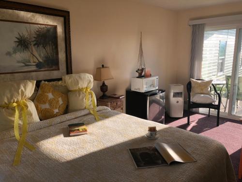 a bedroom with a bed with a book on it at Savannah House Wine Country Inn & Cottages in Himrod