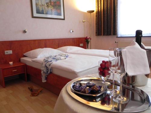Bahnhof-Hotel Saarlouis في سارلويس: غرفة في الفندق مع صينية من الطعام على طاولة