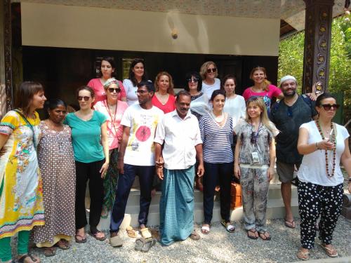 a group of people standing in front of a building at Munroe Coconut Homestay in Munroe Island