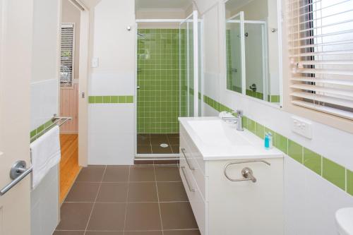 a bathroom with a sink and a shower at BIG4 Park Beach Holiday Park in Coffs Harbour
