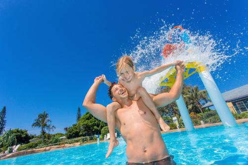a group of people in the water at a pool at BIG4 Park Beach Holiday Park in Coffs Harbour