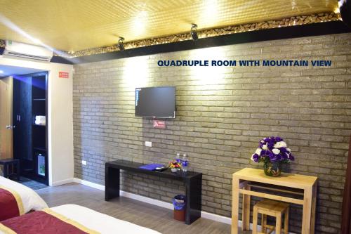 a room with a brick wall with a tv on it at Phuong Nam Hotel in Sa Pa