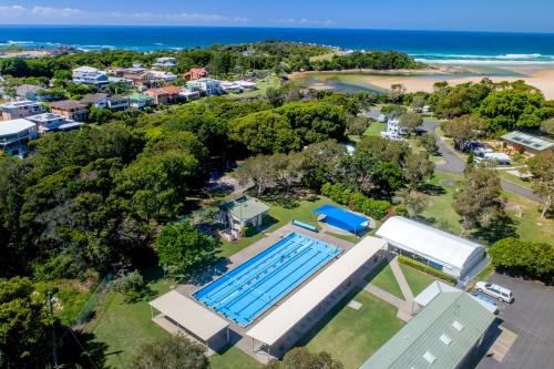 an overhead view of a swimming pool next to a beach at BIG4 Sawtell Beach Holiday Park in Sawtell