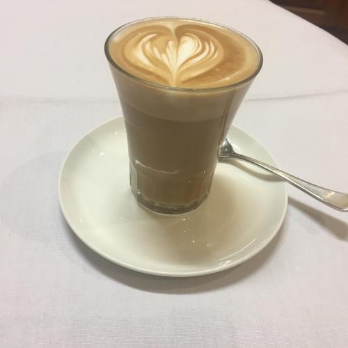 a cup of coffee on a plate on a table at Barossa House in Tanunda