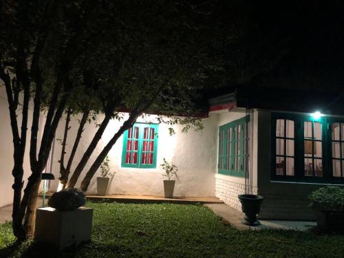 a house with green and red windows at night at Ella Escapade Hostel in Ella