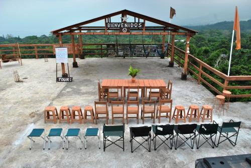 a table and chairs in front of a pavilion at Cabañas Ecobiosfera in Catemaco