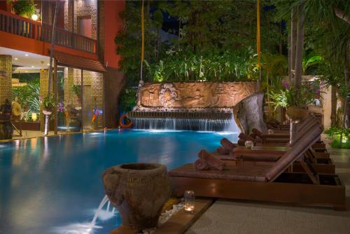 a swimming pool with a waterfall in a hotel at Golden Temple Hotel in Siem Reap