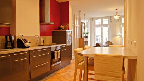 une cuisine avec un comptoir et une table à l'intérieur dans l'établissement Little Suite - Antonin, à Lille