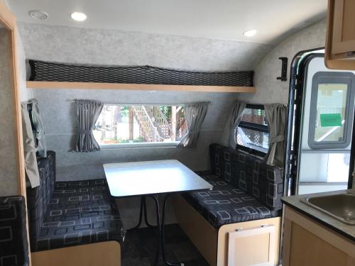 an rv with a table and chairs in it at DogrunCafe & Resorts JENNIE West-Karuizawa in Miyota