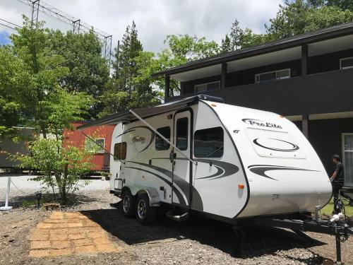 a white trailer parked in front of a building at DogrunCafe & Resorts JENNIE West-Karuizawa in Miyota