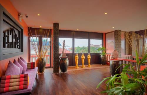 a living room with a couch and some plants at Golden Temple Hotel in Siem Reap