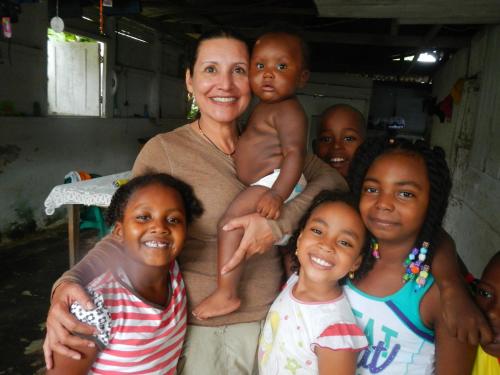 a woman holding a baby and a group of girls at Ecolodge el Arca Bahia Solano in Bahía Solano