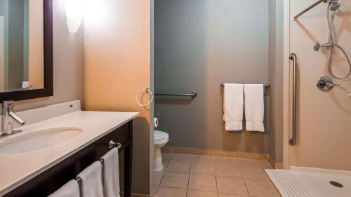 a bathroom with a sink and a toilet at Best Western Plus - Magee Inn & Suites in Magee