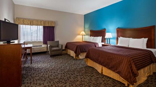 a hotel room with two beds and a flat screen tv at Best Western Chambersburg in Chambersburg
