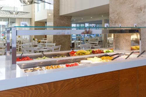 a buffet line with many different types of food at Best Western Plus Hotel Plaza in Rhodes Town