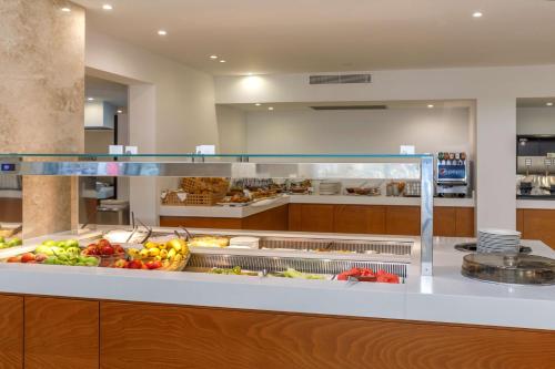 a buffet line with fruits and vegetables on display at Best Western Plus Hotel Plaza in Rhodes Town