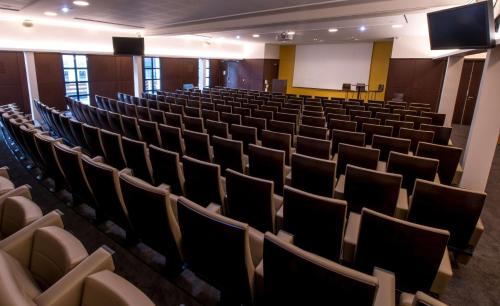 an empty lecture hall with chairs and a screen at Best Western Premier Hotel de la Paix in Reims